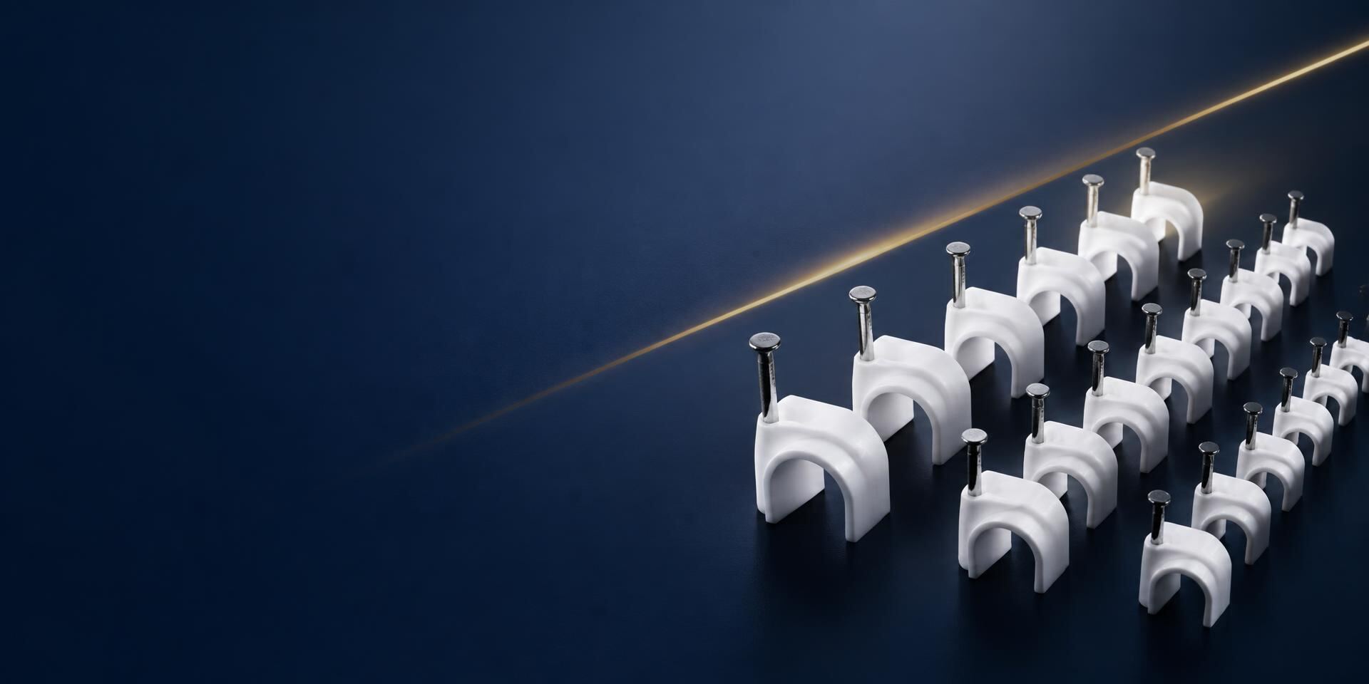 Rows of white PVC nail cable clips manufactured by Shri Krishna Industries